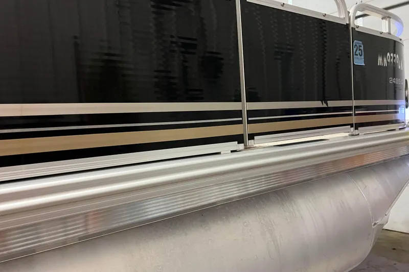 Slide: The Image of 2014 Avalon Grand Island 2485 QF pontoon boat with sleek black and silver design. - 34