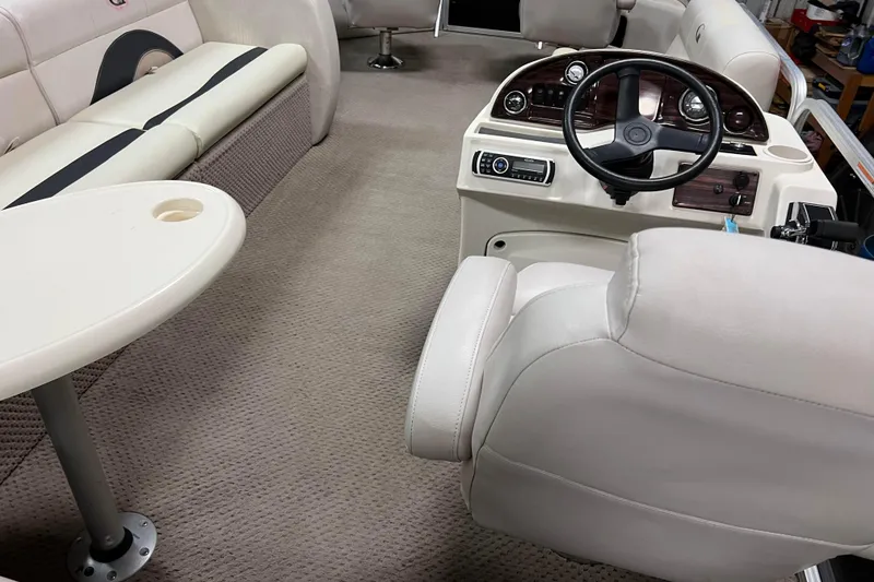 Slide: The Image of 2014 Avalon Grand Island 2485 QF interior with steering console and seating. - 44