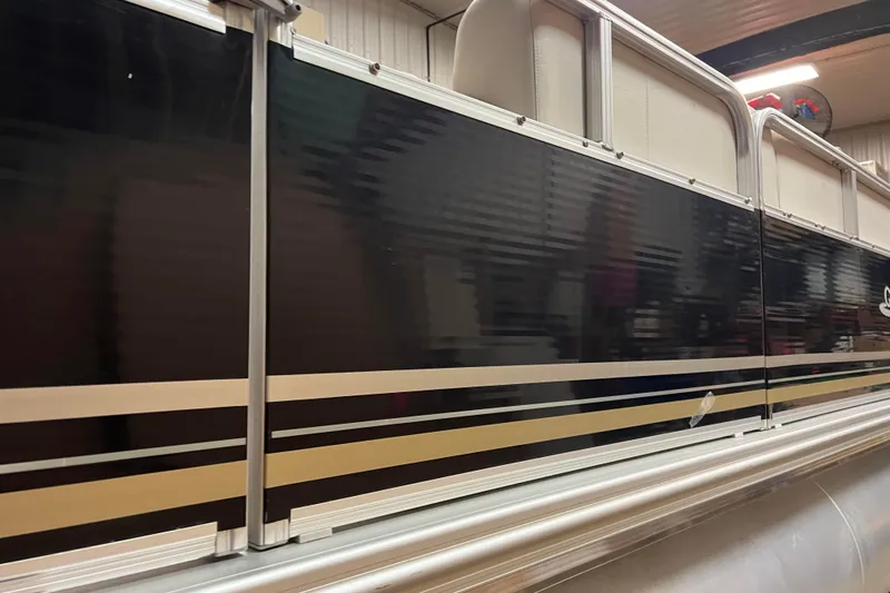 Slide: The Image of 2014 Avalon Grand Island 2485 QF pontoon boat with sleek black and gold exterior. - 46