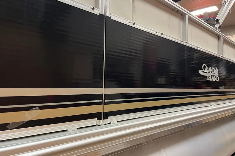 Slide: The Image of 2014 Avalon Grand Island 2485 QF pontoon boat side view with logo. - 48