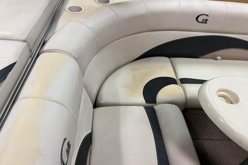 Slide: The Image of 2014 Avalon Grand Island 2485 QF boat interior with cushioned seating and cup holders. - 51