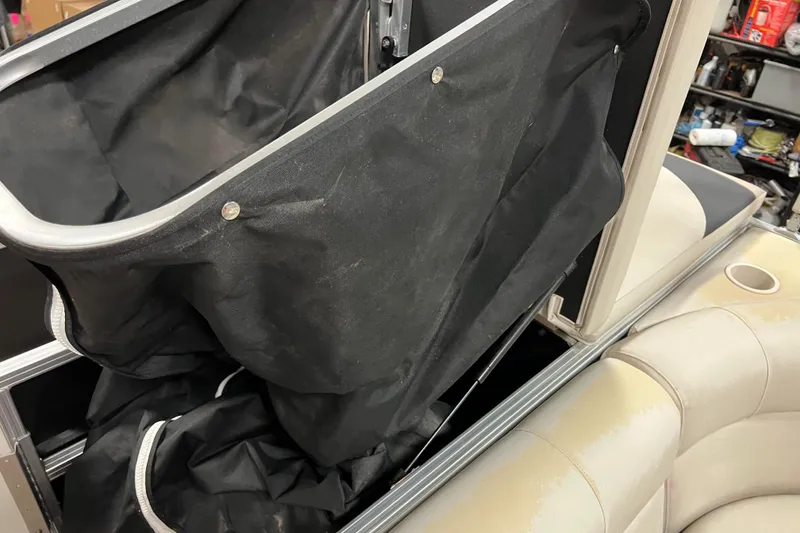 Slide: The Image of 2014 Avalon Grand Island 2485 QF boat interior with black storage compartment. - 54