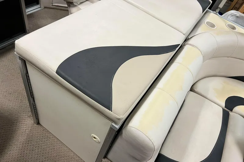 Slide: The Image of 2014 Avalon Grand Island 2485 QF boat seating with beige and black upholstery. - 55