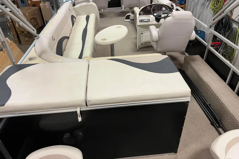 Slide: The Image of 2014 Avalon Grand Island 2485 QF pontoon boat interior with plush seating and steering console. - 69