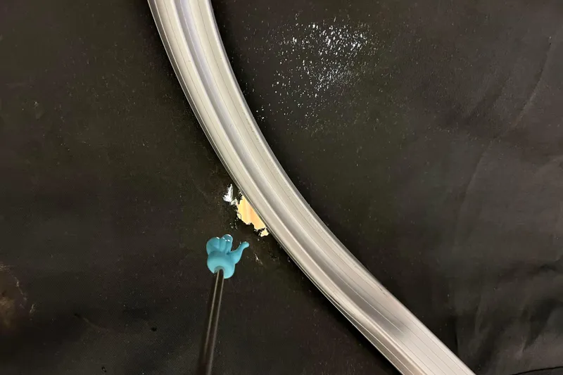 Slide: The Image of Close-up of Avalon Grand Island 2485 QF 2014 component with blue tool on black surface. - 80