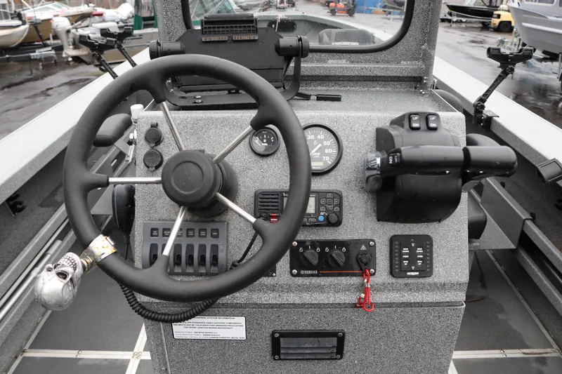Slide: The Image of 2022 North River Osprey boat dashboard with steering wheel and control panel. - 10