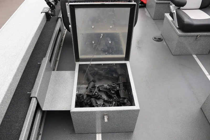 Slide: The Image of Open storage compartment on 2022 North River Osprey boat, containing various black components. - 11
