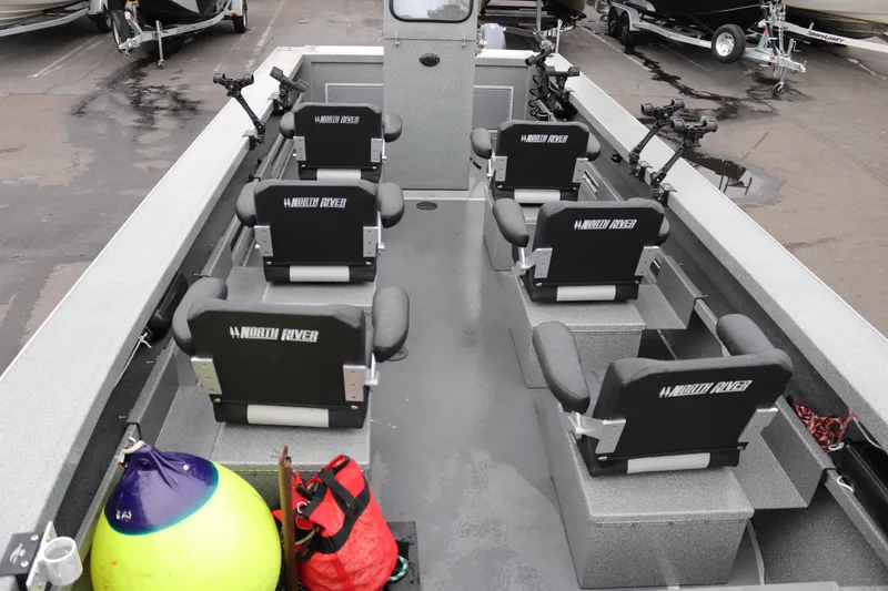 Slide: The Image of 2022 North River Osprey boat interior with seating and fishing rod holders. - 13