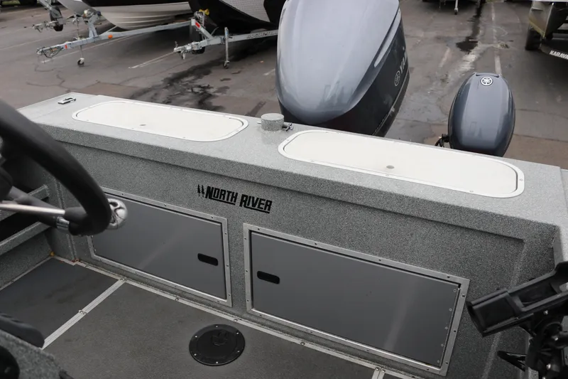 Slide: The Image of 2022 North River Osprey boat interior with storage compartments and steering wheel. - 16