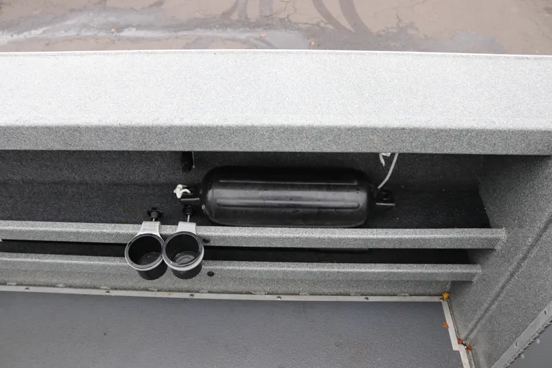 Slide: The Image of 2022 North River Osprey boat interior with cup holders and storage compartment. - 17