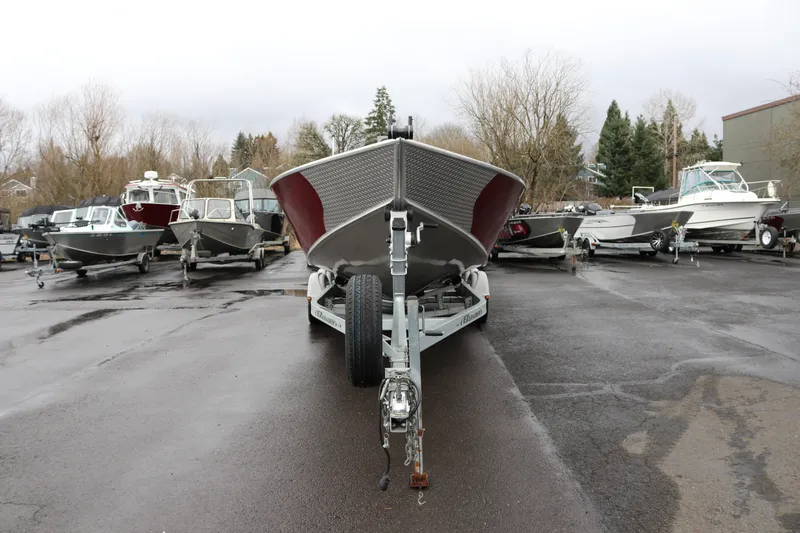 Slide: The Image of 2022 North River Osprey boat on trailer in parking lot with other boats. - 2