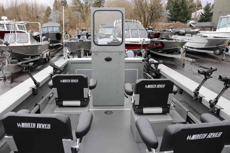 Slide: The Image of 2022 North River Osprey boat interior with seating and fishing rod holders. - 22