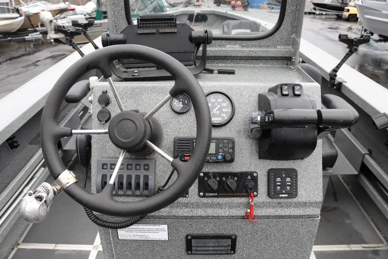 Slide: The Image of 2022 North River Osprey boat dashboard with steering wheel and control panel. - 23