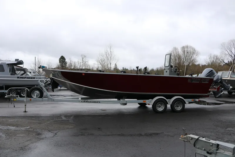 Slide: The Image of 2022 North River Osprey boat on trailer in outdoor setting, overcast sky. - 24