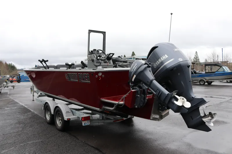 Slide: The Image of 2022 North River Osprey boat with Yamaha outboard motor on a trailer. - 3