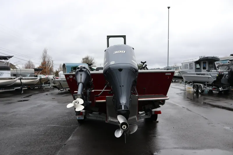 Slide: The Image of 2022 North River Osprey boat with dual outboard motors in a marina setting. - 4