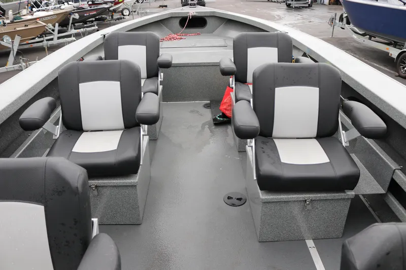 Slide: The Image of Interior of a 2022 North River Osprey boat with four cushioned seats. - 6