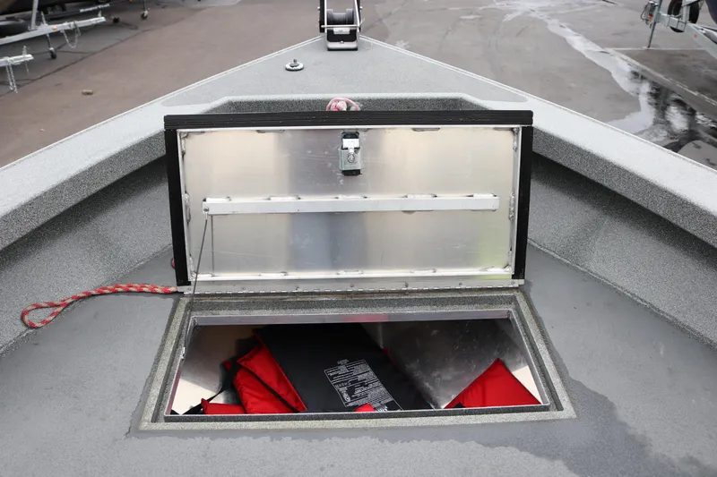 Slide: The Image of Open storage compartment on 2022 North River Osprey boat, showing interior with red life jackets. - 8