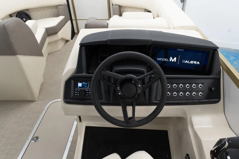 Slide: The Image of 2026 Alera M23Q boat interior with modern steering console and seating. - 12