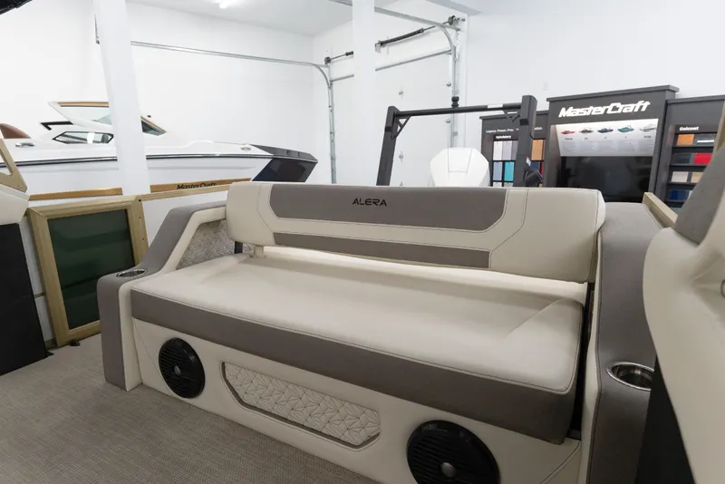 Slide: The Image of Luxury seating in a 2026 Alera M23Q boat showroom with MasterCraft display. - 15