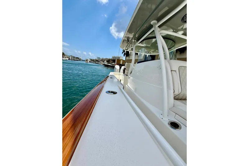 Slide: The Image of 2024 Valhalla Boatworks V-37, sleek design, docked on calm waters under blue sky. - 10
