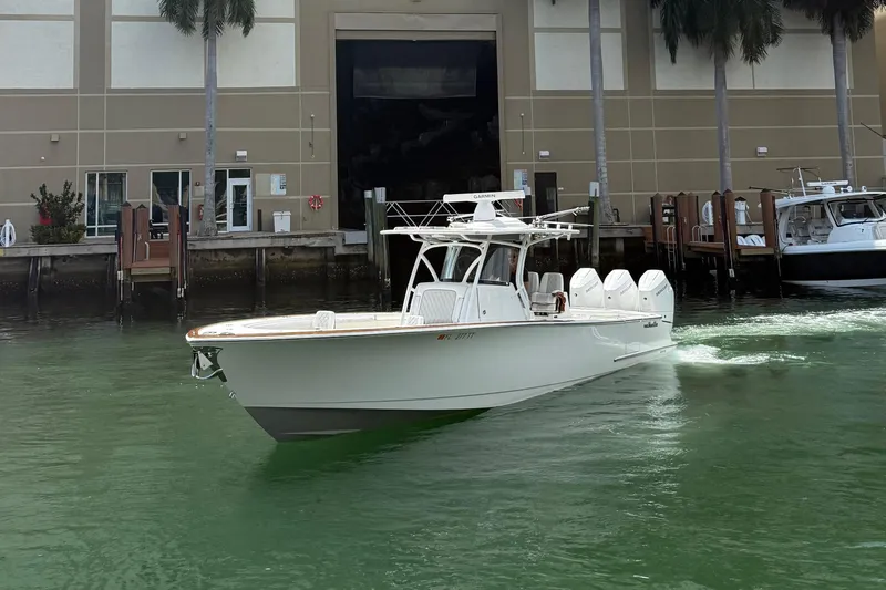 Slide: The Image of 2024 Valhalla Boatworks V-37 cruising near a dock, showcasing sleek design and powerful engines. - 3