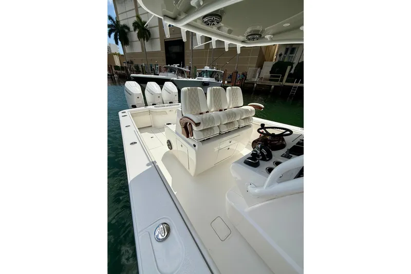 Slide: The Image of 2024 Valhalla Boatworks V-37 with luxurious seating and sleek design in marina setting. - 13