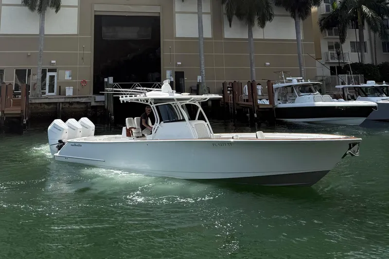 Slide: The Image of 2024 Valhalla Boatworks V-37 cruising in marina, showcasing sleek design and powerful engines. - 1