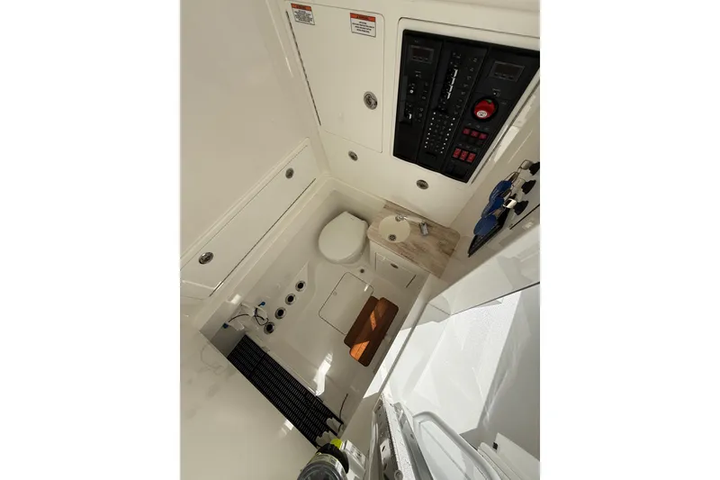 Slide: The Image of 2024 Valhalla Boatworks V-37 interior cabin with control panel and compact amenities. - 17