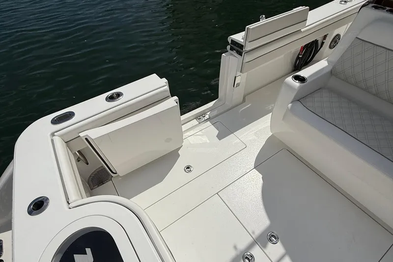 Slide: The Image of 2024 Valhalla Boatworks V-37 deck with seating and cup holders by the water. - 14