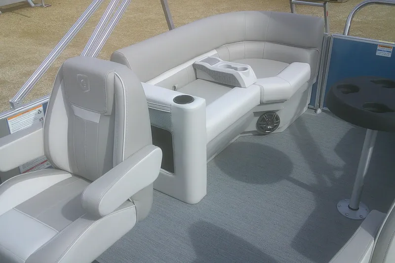 Slide: The Image of 2026 Godfrey EX 2286 SBX boat interior with plush seating and cup holders. - 11