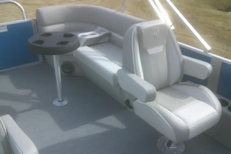 Slide: The Image of Luxurious seating on 2026 Godfrey EX 2286 SBX pontoon boat with cup holder table. - 12