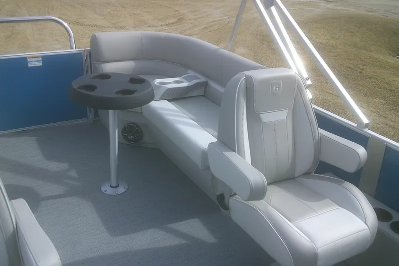 Slide: The Image of 2026 Godfrey EX 2286 SBX pontoon boat interior with plush seating and cup holders. - 13