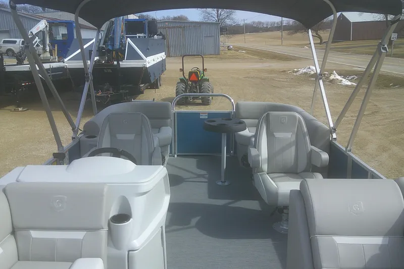 Slide: The Image of 2026 Godfrey EX 2286 SBX pontoon boat interior with seating and steering wheel. - 5