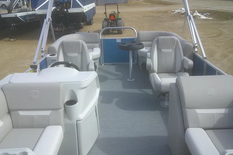Slide: The Image of 2026 Godfrey EX 2286 SBX pontoon boat interior with plush seating and steering console. - 6