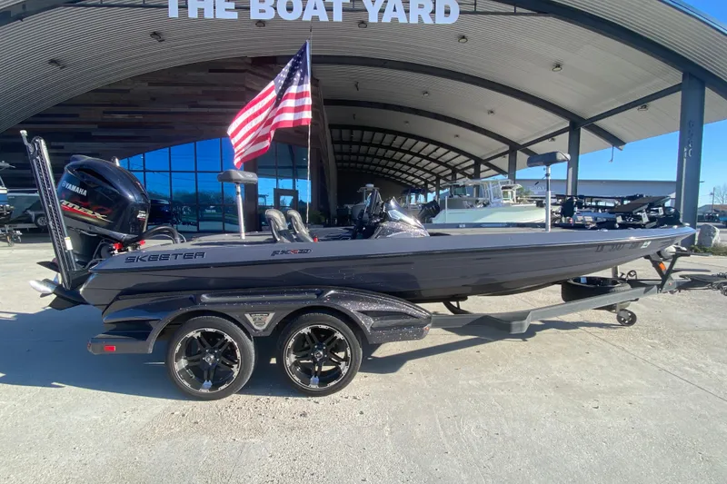 Slide: The Image of 2020 Skeeter FXR20 Limited boat with Yamaha engine at dealership, American flag displayed. - 3