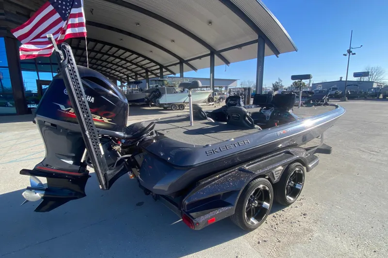 Slide: The Image of 2020 Skeeter FXR20 Limited boat with Yamaha engine, parked outdoors under a canopy. - 4