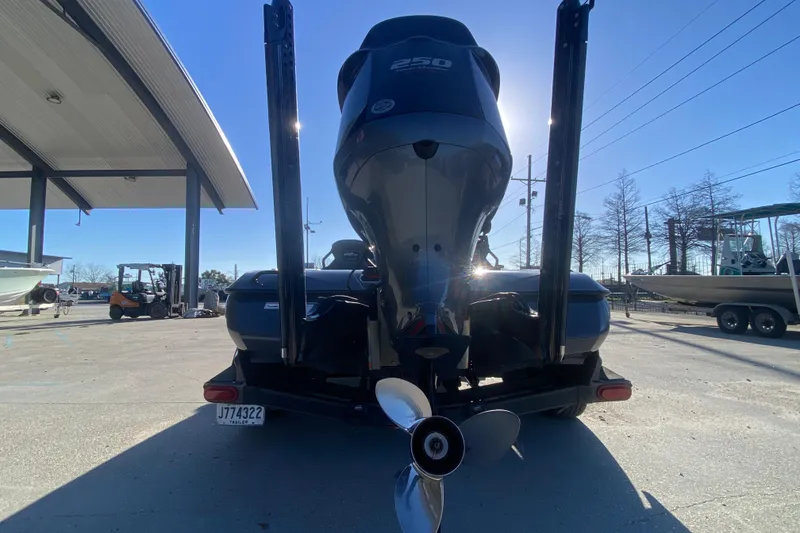 Slide: The Image of 2020 Skeeter FXR20 Limited boat with powerful outboard motor in a sunny marina. - 5