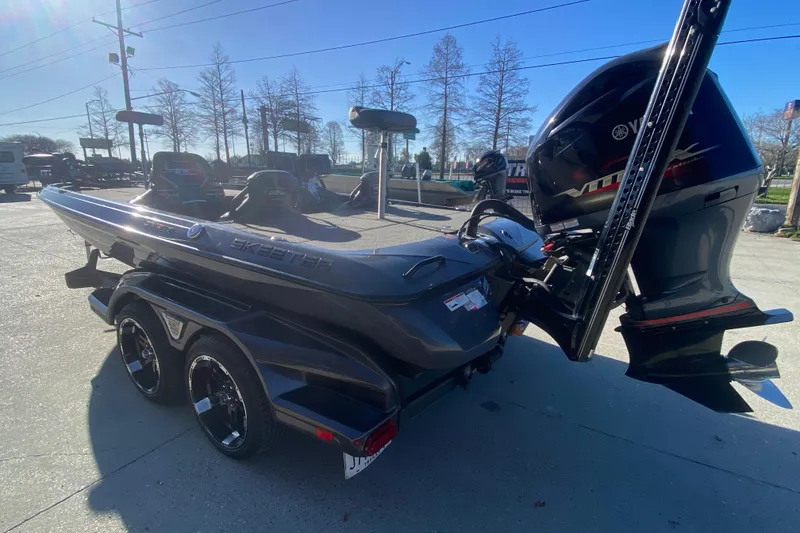 Slide: The Image of 2020 Skeeter FXR20 Limited boat with Yamaha engine on trailer, parked outdoors. - 6