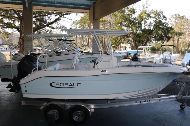The Image of 2026 Robalo R202 Explorer boat on trailer in marina setting. - 0