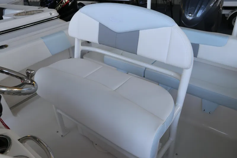 Slide: The Image of 2026 Robalo R202 Explorer boat interior with white and gray seating. - 18