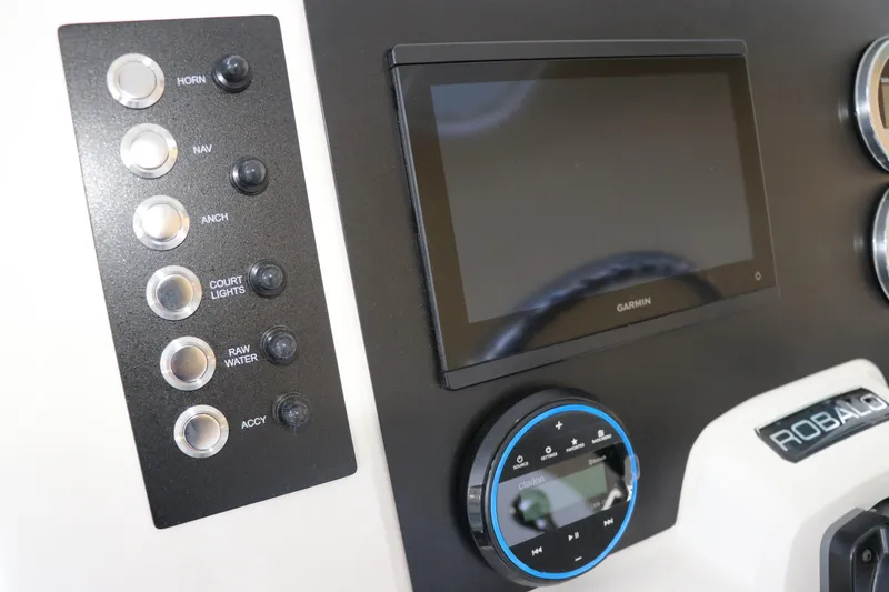 Slide: The Image of Control panel of 2026 Robalo R202 Explorer boat with Garmin display and switches. - 20