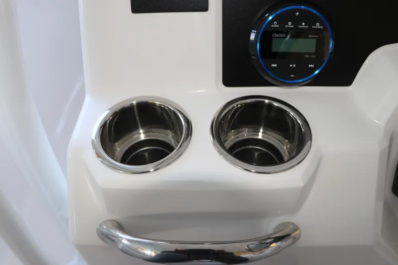 Slide: The Image of 2026 Robalo R202 Explorer boat console with cup holders and audio controls. - 21