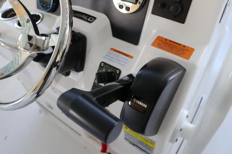 Slide: The Image of 2026 Robalo R202 Explorer boat dashboard with Yamaha throttle and steering wheel. - 24