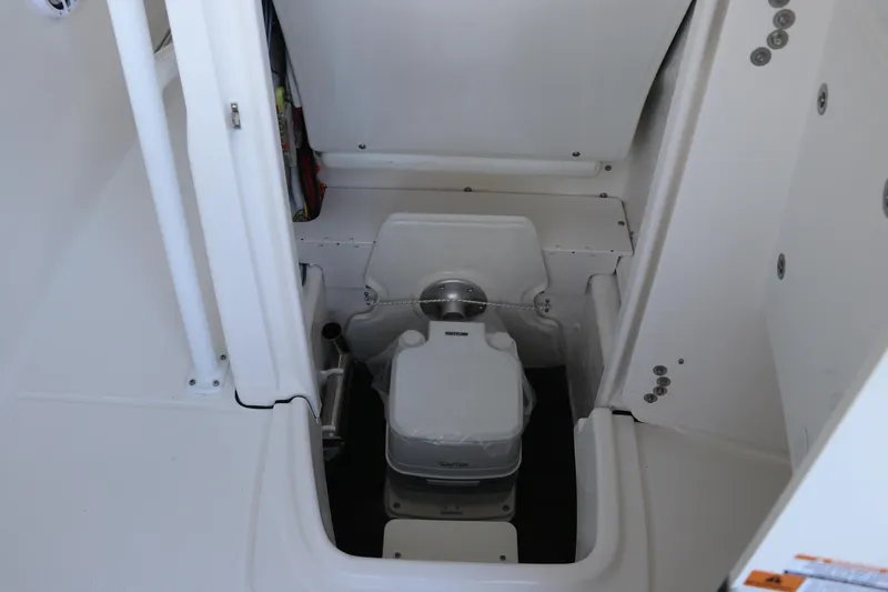 Slide: The Image of 2026 Robalo R202 Explorer boat interior with compact marine toilet. - 29