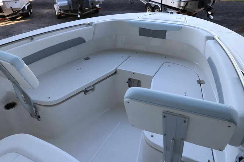 Slide: The Image of 2026 Robalo R202 Explorer boat interior with cushioned seating and storage compartments. - 31