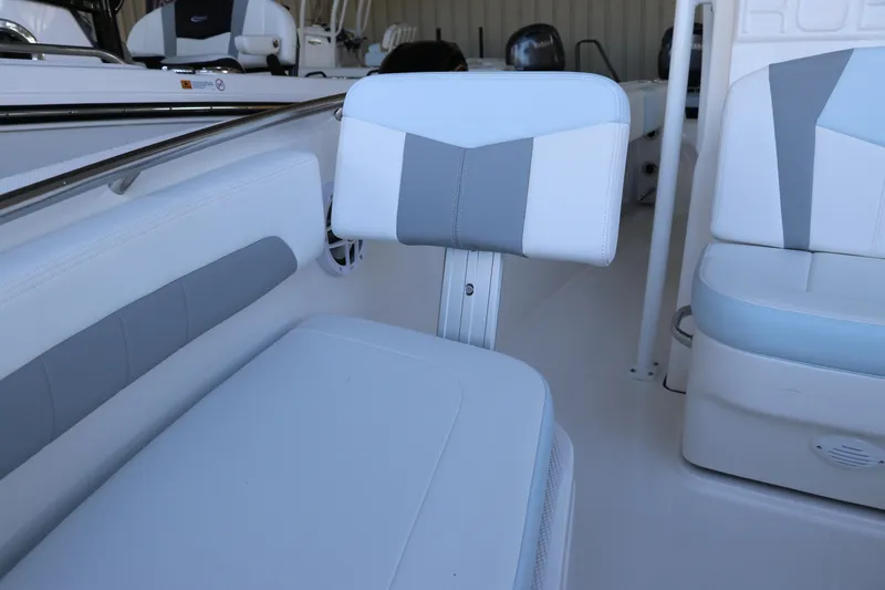 Slide: The Image of 2026 Robalo R202 Explorer boat interior with white and gray seating. - 34