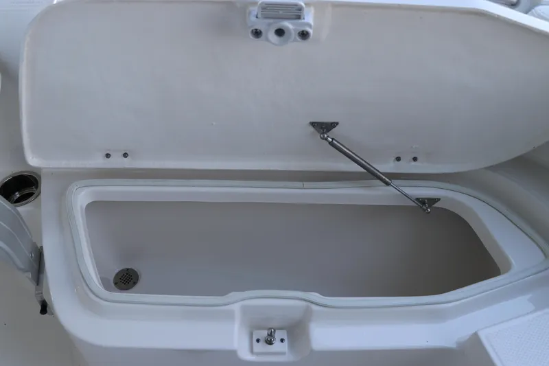 Slide: The Image of Open storage compartment on 2026 Robalo R202 Explorer boat. - 38