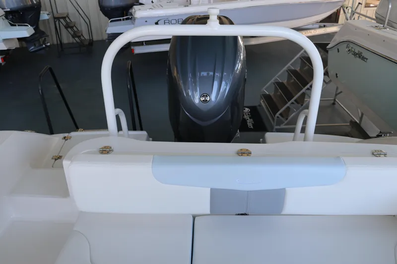 Slide: The Image of 2026 Robalo R202 Explorer boat interior with engine view in showroom. - 9