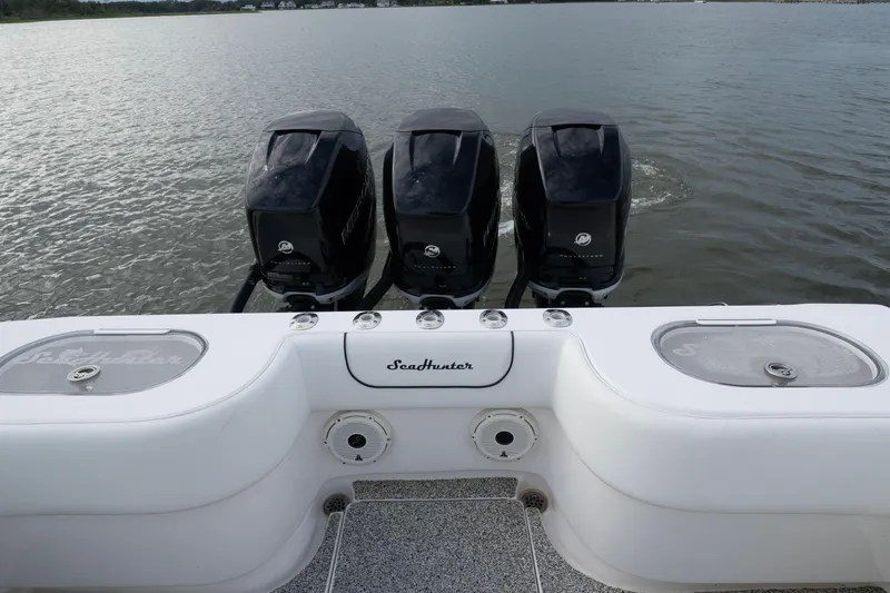 Slide: The Image of 2012 SeaHunter 37 Tournament boat with triple Mercury outboard engines on calm water. - 10